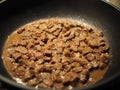 Meat goulash from chicken fillet and onion with spices fry in a pan on the stove. Delicious simple dish close-up Royalty Free Stock Photo