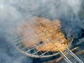 Meat on the grill and heavy smoke above brazier. Weekend. Picnic.