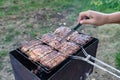 Meat on the grill. knife readiness check Royalty Free Stock Photo