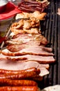 Meat on grill, preparing delicious food - meal such as sausages, pork and chicken meat