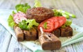 Meat grilled burger on a wooden board with vegetables