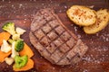 Meat grilled ribai with vegetables. Ribai steak on wooden board. Close up