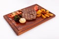 Meat grilled ribai with vegetables. Ribai steak on wooden board. Close up