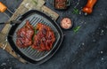 Meat grilling pork steak with herbs and spices on the grill pan. banner, menu, recipe place for text, top view Royalty Free Stock Photo