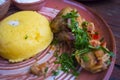 Meat with herbs and mamalyga on dishes in the national style Royalty Free Stock Photo