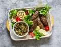 Meat kebab , grilled vegetables sauce, zucchini, flatbread, green salad - a delicious mediterranean style lunch on a gray Royalty Free Stock Photo