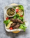 Meat kebab , grilled vegetables sauce, zucchini, flatbread, green salad - a delicious mediterranean style lunch on a gray Royalty Free Stock Photo