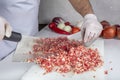 Chef is chopping the raw beef on cutting board with knife to cook in the kitchen, minced beef. Kebab restaurant, kebab preparation