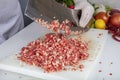 Chef is chopping the raw beef on cutting board with knife to cook in the kitchen, minced beef. Kebab restaurant, kebab preparation