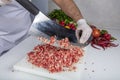 Chef is chopping the raw beef on cutting board with knife to cook in the kitchen, minced beef. Kebab restaurant, kebab preparation