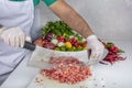 Chef is chopping the raw beef on cutting board with knife to cook in the kitchen, minced beef. Kebab restaurant, kebab preparation