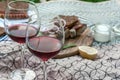 Meat kebab is visible through a glass of red wine. Soft focus