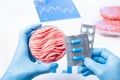 Meat in lab Perti dish and pills blisters in scientist hands. Antibiotic use in livestock research Royalty Free Stock Photo