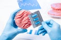 Meat in lab Perti dish and pills in scientist hands. Antibiotic use in livestock Royalty Free Stock Photo