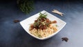 meat lamb vermicelli rice in rose mary sauce served in dish isolated on table top view of arabic food