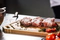 Meat lay at planked. Closeup slice of raw beef at kitchen table.