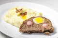meat loaf filled with egg and sausage served with mashed potatoes and fried onion Royalty Free Stock Photo