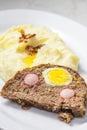 meat loaf filled with egg and sausage served with mashed potatoes and fried onion Royalty Free Stock Photo