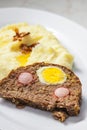 meat loaf filled with egg and sausage served with mashed potatoes and fried onion Royalty Free Stock Photo