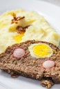 meat loaf filled with egg and sausage served with mashed potatoes and fried onion Royalty Free Stock Photo