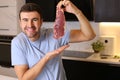 Meat lover showing a delicious raw steak Royalty Free Stock Photo