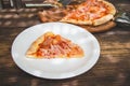 Meat lovers pizza with topping pepperoni salami sausage and ham on wooden table Royalty Free Stock Photo