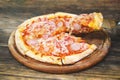 Meat lovers pizza with topping pepperoni salami sausage and ham on wooden table Royalty Free Stock Photo