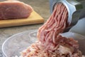 The meat mincer does stuffing. The process of grinding meat close-up.