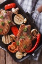 Meat with mushrooms in a pan grill. vertical top view closeup Royalty Free Stock Photo