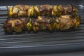 Meat and pepper skewers in a non-stick pan. Royalty Free Stock Photo