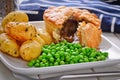 Meat pie with new potatoes and peas. Royalty Free Stock Photo