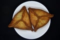 Meat pies on a white plate. Belyashi. Delicious meat pies on a black background Royalty Free Stock Photo