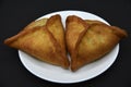 Meat pies on a white plate. Belyashi. Delicious meat pies on a black background Royalty Free Stock Photo