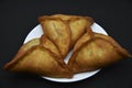 Meat pies on a white plate. Belyashi. Delicious meat pies on a black background Royalty Free Stock Photo