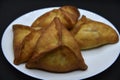 Meat pies on a white plate. Belyashi. Delicious meat pies on a black background Royalty Free Stock Photo