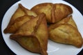 Meat pies on a white plate. Belyashi. Delicious meat pies on a black background Royalty Free Stock Photo