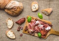 Meat plate on rustic wood board over a rough sackcloth background Royalty Free Stock Photo