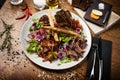 Meat platter for two: Dry-aged beef brisket, duck fillet, beef liver pate, lamb striploin, cranberry jam and grissini Royalty Free Stock Photo
