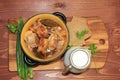 Meat in a pot, a jug of milk and onions with parsley, top view. Royalty Free Stock Photo