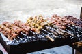 Meat and potatoes prepared for frying on skewers.