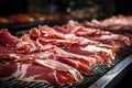 Meat processing plant. Slices of fresh bacon and mint slices on a conveyor belt in the workshop. Arrival of jamon or cold cuts.