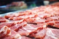 Meat processing plant. Slices of fresh bacon and mint slices on a conveyor belt in the workshop. Arrival of jamon or cold cuts.