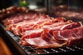 Meat processing plant. Slices of fresh bacon and mint slices on a conveyor belt in the workshop. Arrival of jamon or cold cuts.