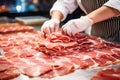 Meat processing plant. A worker sorts cold cuts on a conveyor belt. Arrival of jamon or cold cuts. Production of pork or beef in a