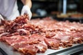 Meat processing plant. A worker sorts cold cuts on a conveyor belt. Arrival of jamon or cold cuts. Production of pork or beef in a