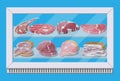Meat products in supermarket fridge.