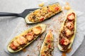 Meat and quinoa stuffed zucchini boats on light table Royalty Free Stock Photo