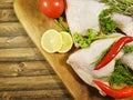 Meat raw chicken leg greens lemon, red chili pepper, nutrition tomato Royalty Free Stock Photo