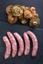 meat raw sausages and mushrooms as autumn food Royalty Free Stock Photo