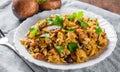 Meat with Rice, mushroom and vegetables in white plate on wooden table Royalty Free Stock Photo